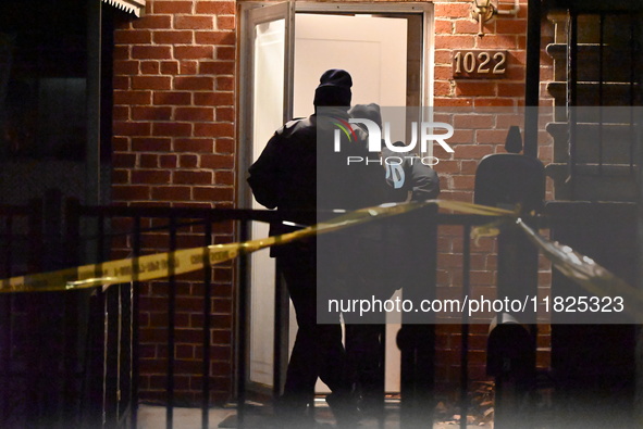 NYPD crime scene investigators search for evidence at the scene where a 30-year-old man is killed in an assault in the Throggs Neck section...