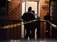 NYPD crime scene investigators search for evidence at the scene where a 30-year-old man is killed in an assault in the Throggs Neck section...