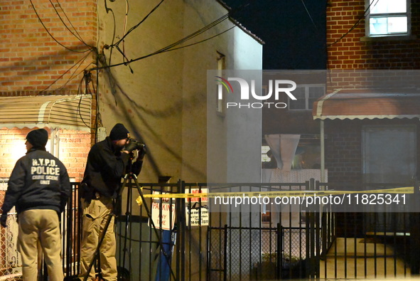 NYPD crime scene investigators search for evidence at the scene where a 30-year-old man is killed in an assault in the Throggs Neck section...