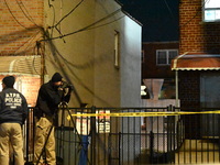 NYPD crime scene investigators search for evidence at the scene where a 30-year-old man is killed in an assault in the Throggs Neck section...