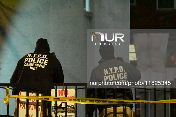 NYPD crime scene investigators search for evidence at the scene where a 30-year-old man is killed in an assault in the Throggs Neck section...