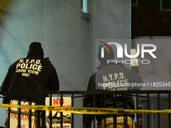 NYPD crime scene investigators search for evidence at the scene where a 30-year-old man is killed in an assault in the Throggs Neck section...