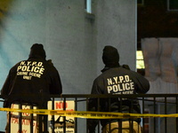 NYPD crime scene investigators search for evidence at the scene where a 30-year-old man is killed in an assault in the Throggs Neck section...