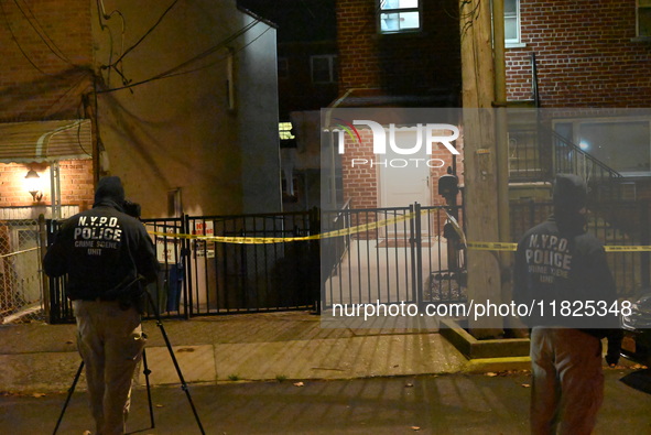 NYPD crime scene investigators search for evidence at the scene where a 30-year-old man is killed in an assault in the Throggs Neck section...