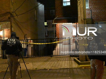 NYPD crime scene investigators search for evidence at the scene where a 30-year-old man is killed in an assault in the Throggs Neck section...