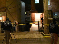 NYPD crime scene investigators search for evidence at the scene where a 30-year-old man is killed in an assault in the Throggs Neck section...