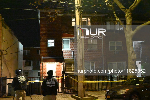 NYPD crime scene investigators search for evidence at the scene where a 30-year-old man is killed in an assault in the Throggs Neck section...