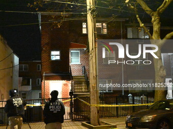 NYPD crime scene investigators search for evidence at the scene where a 30-year-old man is killed in an assault in the Throggs Neck section...