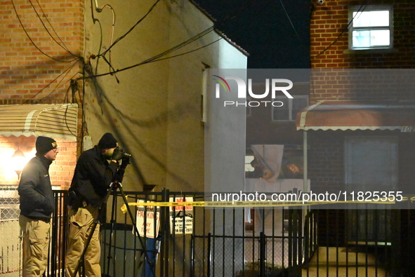 NYPD crime scene investigators search for evidence at the scene where a 30-year-old man is killed in an assault in the Throggs Neck section...