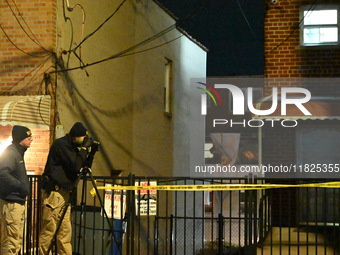 NYPD crime scene investigators search for evidence at the scene where a 30-year-old man is killed in an assault in the Throggs Neck section...