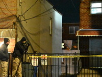 NYPD crime scene investigators search for evidence at the scene where a 30-year-old man is killed in an assault in the Throggs Neck section...