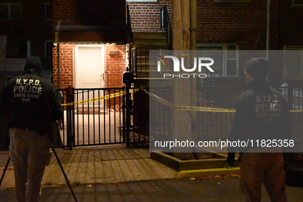 NYPD crime scene investigators search for evidence at the scene where a 30-year-old man is killed in an assault in the Throggs Neck section...