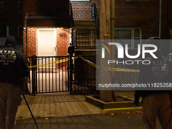 NYPD crime scene investigators search for evidence at the scene where a 30-year-old man is killed in an assault in the Throggs Neck section...