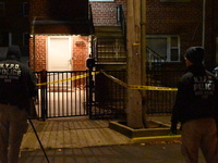 NYPD crime scene investigators search for evidence at the scene where a 30-year-old man is killed in an assault in the Throggs Neck section...