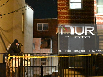 NYPD crime scene investigators search for evidence at the scene where a 30-year-old man is killed in an assault in the Throggs Neck section...