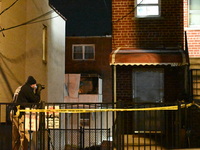 NYPD crime scene investigators search for evidence at the scene where a 30-year-old man is killed in an assault in the Throggs Neck section...