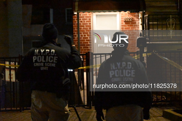 NYPD crime scene investigators search for evidence at the scene where a 30-year-old man is killed in an assault in the Throggs Neck section...