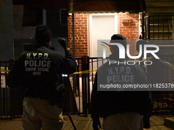 NYPD crime scene investigators search for evidence at the scene where a 30-year-old man is killed in an assault in the Throggs Neck section...