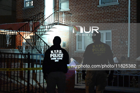 NYPD crime scene investigators search for evidence at the scene where a 30-year-old man is killed in an assault in the Throggs Neck section...