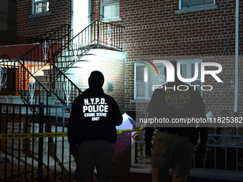 NYPD crime scene investigators search for evidence at the scene where a 30-year-old man is killed in an assault in the Throggs Neck section...