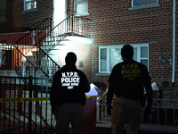 NYPD crime scene investigators search for evidence at the scene where a 30-year-old man is killed in an assault in the Throggs Neck section...