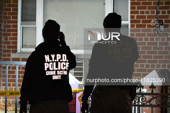 NYPD crime scene investigators search for evidence at the scene where a 30-year-old man is killed in an assault in the Throggs Neck section...