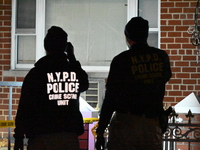 NYPD crime scene investigators search for evidence at the scene where a 30-year-old man is killed in an assault in the Throggs Neck section...