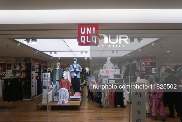 Customers shop at a UNIQLO store in Hangzhou, Zhejiang province, China, on December 1, 2024. 