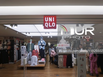 Customers shop at a UNIQLO store in Hangzhou, Zhejiang province, China, on December 1, 2024. (