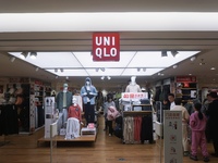 Customers shop at a UNIQLO store in Hangzhou, Zhejiang province, China, on December 1, 2024. (