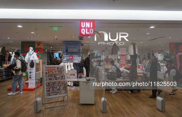 Customers shop at a UNIQLO store in Hangzhou, Zhejiang province, China, on December 1, 2024. 