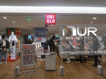 Customers shop at a UNIQLO store in Hangzhou, Zhejiang province, China, on December 1, 2024. (