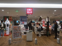 Customers shop at a UNIQLO store in Hangzhou, Zhejiang province, China, on December 1, 2024. (