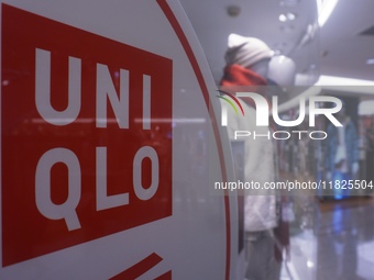 Customers shop at a UNIQLO store in Hangzhou, Zhejiang province, China, on December 1, 2024. (