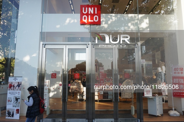 A citizen passes a UNIQLO store in Hangzhou, China, on December 1, 2024. 