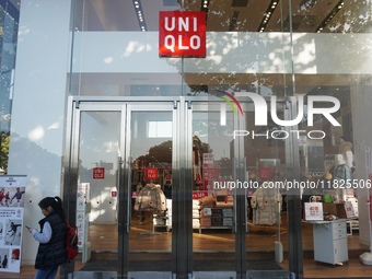 A citizen passes a UNIQLO store in Hangzhou, China, on December 1, 2024. (