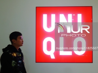 A citizen passes a UNIQLO store in Hangzhou, China, on December 1, 2024. (