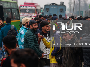 Kashmiri unemployed youth stand outside an examination center in Baramulla, Jammu and Kashmir, India, on December 1, 2024. More than 5.59 la...