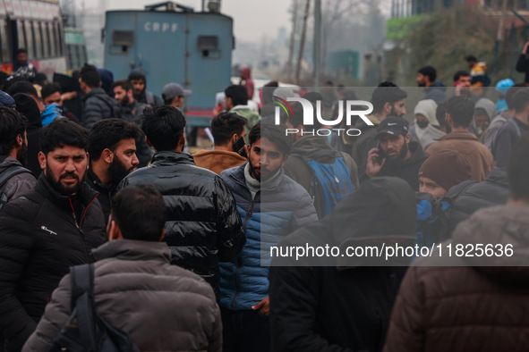 Kashmiri unemployed youth stand outside an examination center in Baramulla, Jammu and Kashmir, India, on December 1, 2024. More than 5.59 la...