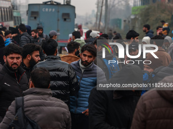 Kashmiri unemployed youth stand outside an examination center in Baramulla, Jammu and Kashmir, India, on December 1, 2024. More than 5.59 la...