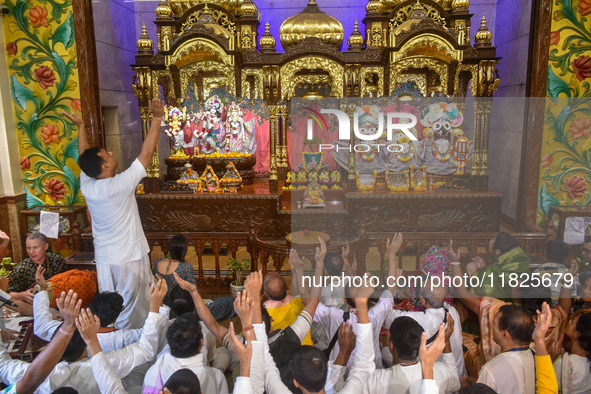 Devotees and members of the International Society for Krishna Consciousness (ISKCON) sing devotional songs during a prayer in Kolkata, India...