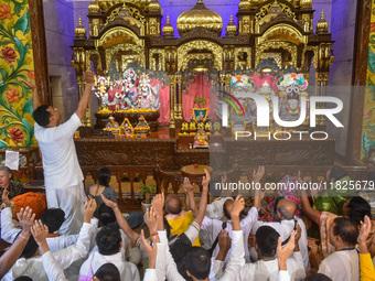 Devotees and members of the International Society for Krishna Consciousness (ISKCON) sing devotional songs during a prayer in Kolkata, India...