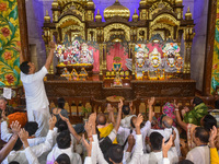 Devotees and members of the International Society for Krishna Consciousness (ISKCON) sing devotional songs during a prayer in Kolkata, India...