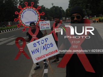 Social activists perform an awareness program on the wayside in observation of World AIDS Day in Bhubaneswar, Odisha, India, on December 1,...