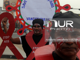 Social Activists Are Seen On Wayside They Are Performing Awareness Program On The Observation Of World AIDs Day In The Eastern Indian State...