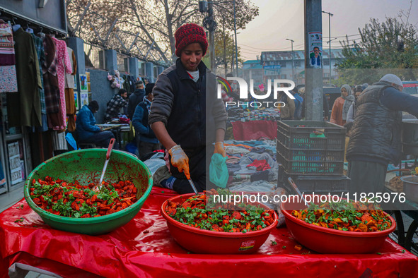 A boy sells various kinds of pickles at a market on a cold winter day in Srinagar, Jammu and Kashmir, on December 01, 2024. 