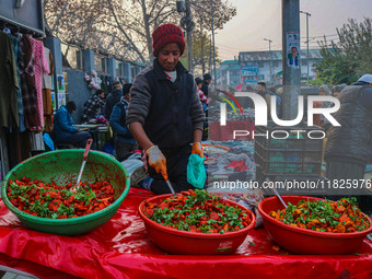 A boy sells various kinds of pickles at a market on a cold winter day in Srinagar, Jammu and Kashmir, on December 01, 2024. (