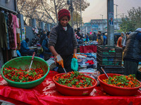 A boy sells various kinds of pickles at a market on a cold winter day in Srinagar, Jammu and Kashmir, on December 01, 2024. (