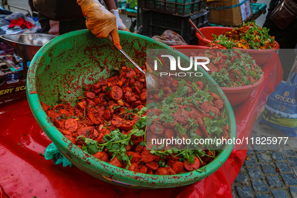 A boy sells various kinds of pickles at a market on a cold winter day in Srinagar, Jammu and Kashmir, on December 01, 2024. 