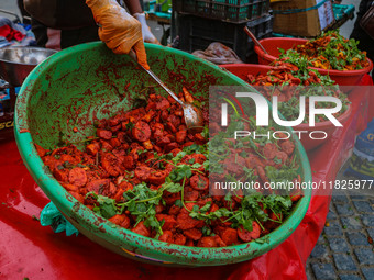 A boy sells various kinds of pickles at a market on a cold winter day in Srinagar, Jammu and Kashmir, on December 01, 2024. (